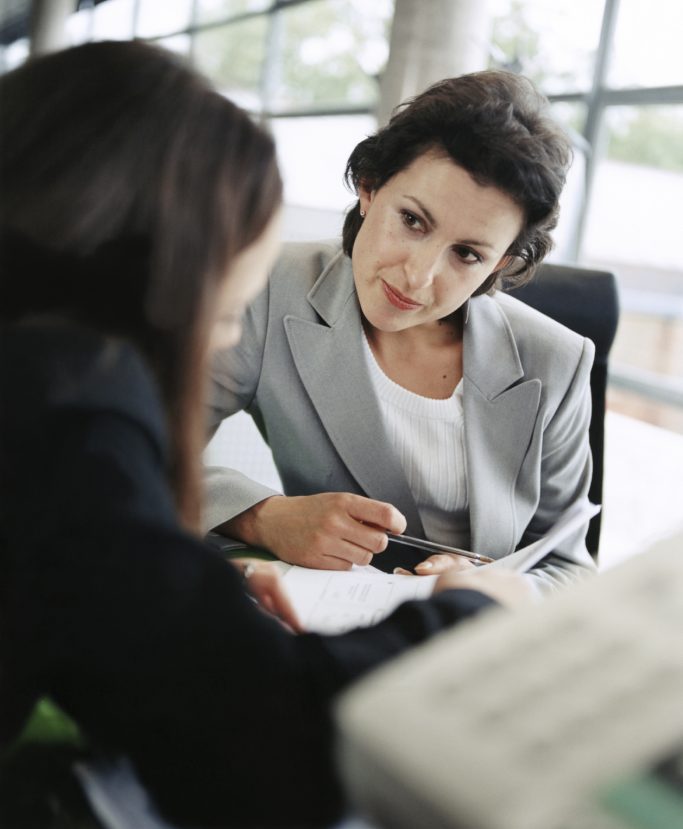 Life coach guiding a client through mindfulness and personal growth exercises"  Highlights mindfulness and personal development in coaching 